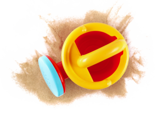 Plastic garden toy for kids, watering can in sand isolated on white background, top view