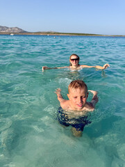 Family Enjoys Swimming in Clear Ocean Water