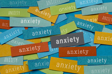 Anxiety feeling, anxious thoughts, many papers with word anxiety written on it, concept