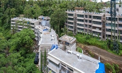 Construction workers build a resort in Ubud, Bali, Indonesia. The building is surrounded by lush...