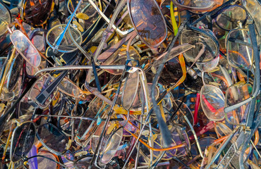 A pile of various old glasses