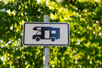German RV Sign on Post with Foliage Background