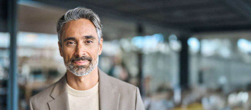 Close up headshot portrait of happy middle aged older professional business man, smiling bearded mature executive ceo manager, older male entrepreneur, rich confident business owner in office.