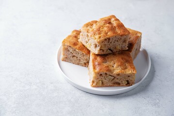 Apple cake in a plate on a white background
