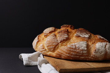 Freshly Baked Artisan Bread displayed on a dark background, highlighting its craftsmanship