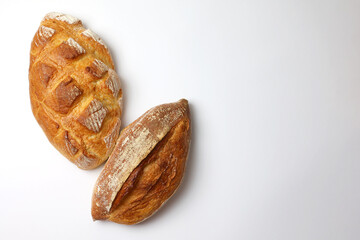Beautiful and delicious artisan bread on a light background, top view