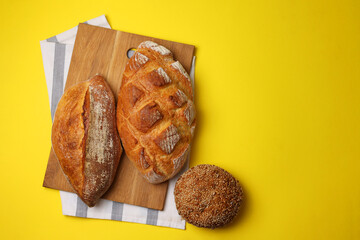 Beautiful and delicious artisan bread on a light background, top view