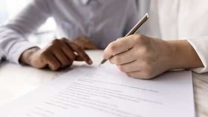 Close up of female hand hold pen and signing real estate contract, buy or sell services, conclude...