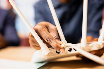 African American couple in a loft struggles with an unstable network, brainstorming solutions to...