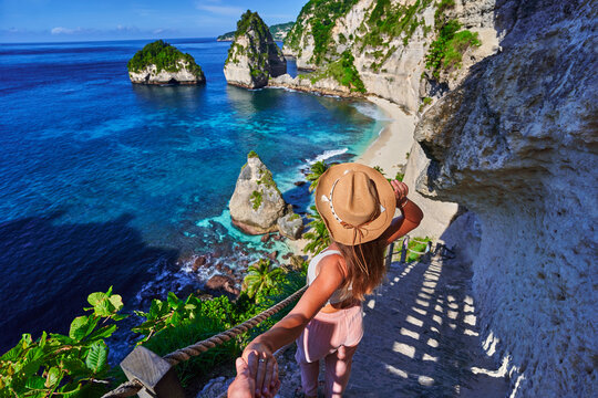 Follow me to scenic way to Diamond beach. Traveling couple on vacation journey holiday to Nusa Penida Island in Indonesia, explore and travel to touristic beautiful destinations, honeymoon together