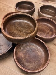 Modern wooden food bowls on table. Natural serving dishes ideal for meze, snacks, or minimalist...