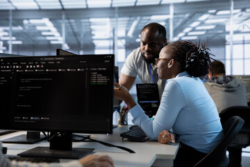 Team of engineers talking in server hub, ensuring compliance with industry standards and regulatory...