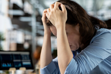 Young employee deals with emotional strain and frustration of business failure, disappointment and...