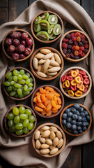 Obraz premium Assortment of fresh fruits and dried fruits in wooden bowls on a table