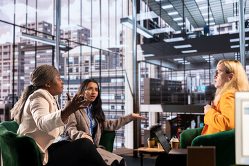 Diverse women executives in a modern office discussing business growth, career development and gender equality. Powerful leaders in action uniting forces to expand the enterprise, progression.