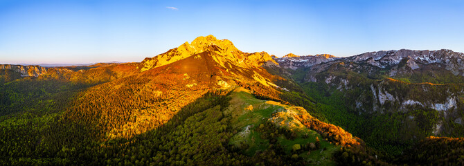 Sutjeska National Park in Bosnia and Herzegovina. Sunset in the mountains of Bosnia in the area of Prijevor and Veliki Maglic. Illuminated mountain massif on the border with Montenegro