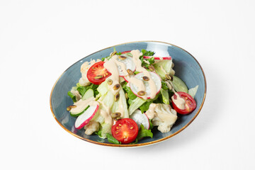A bowl of fresh vegetable salad on a white background