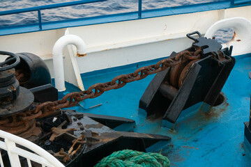 The rusty but fully operational anchor chain on board of offshore support vessel. Anchor is used to...