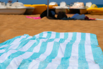 beach towels on an orange sand, sandy seashore beach