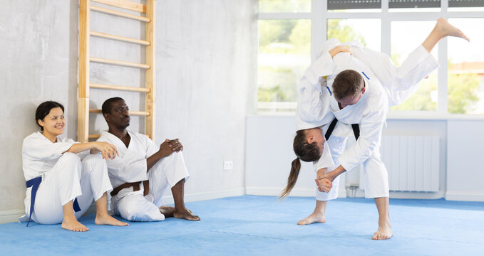 In gym, cosmopolite athletes work in pairs and learn to use classic karate techniques to repel an opponents blow, hone melee skills, strengthen spirit. Sport as lifestyle.