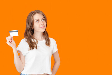 Young Woman Thinking About Purchase With Credit Card