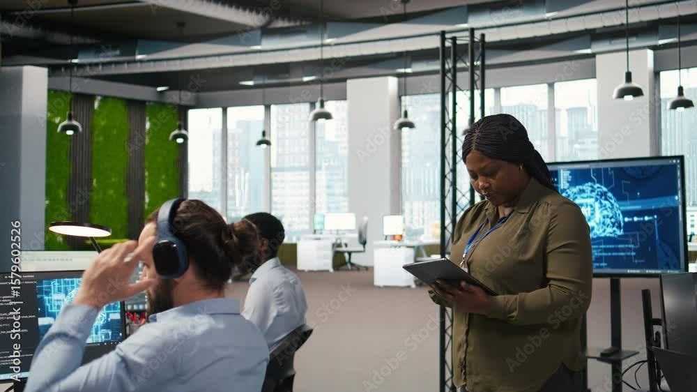 Poster smiling female engineer next to office coworkers developing software applications, integrating ai au
