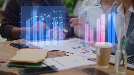 Business professionals analyzing financial data with holographic charts during meeting - Powered by Adobe