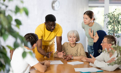 Interested adult African American man participating in volunteer work discussing project or event...