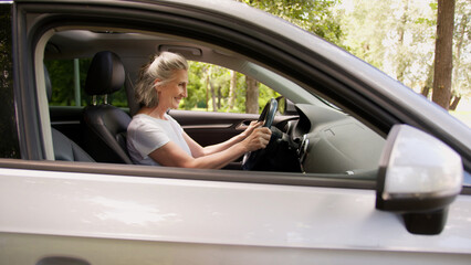 Happy smiling Caucasian aged senior mature woman female rental service client automobile driver...