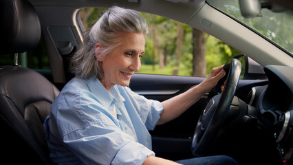 Joyful active smiling Caucasian aged lady woman elderly female senior dealership testing client grandmother auto buyer car driver inside automobile turn on music dancing sing song audio system dance