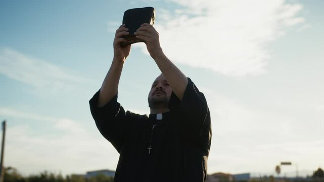 Parson Lifting Up The Bible Towards The Sea 