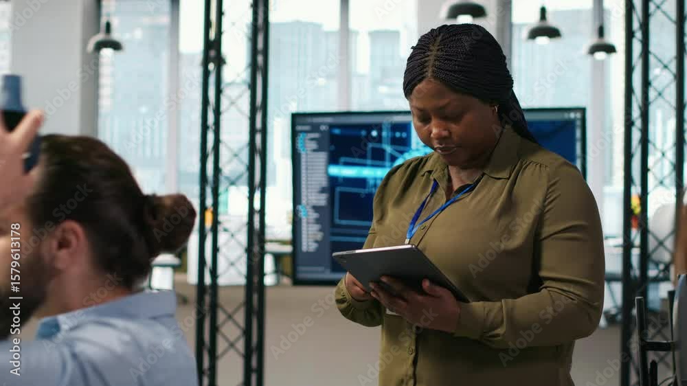 Poster smiling female engineer next to office coworkers developing software applications, integrating ai au