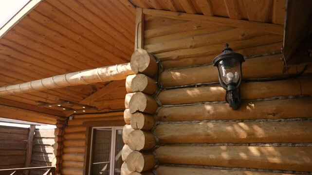 Log cabin exterior with lamp in natural sunlight
