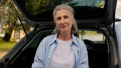 Happy retiree Caucasian senior elderly woman rental service dealership client auto buyer mature...