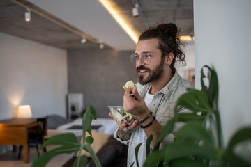 Freelancer enjoying healthy salad at home office