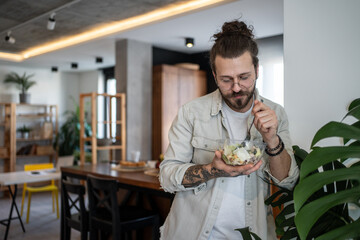 Freelancer enjoying healthy salad in home office during break