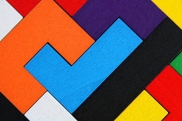 Wooden puzzle pieces with one of them shaped like a check mark, background and texture