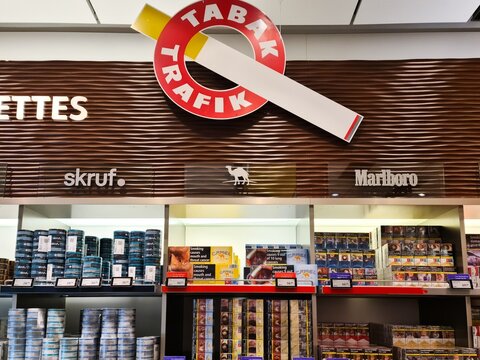 Vienna, Austria - 12. July 2025: Tabak trafik shop displaying various brands of cigarettes and tobacco products in Vienna
