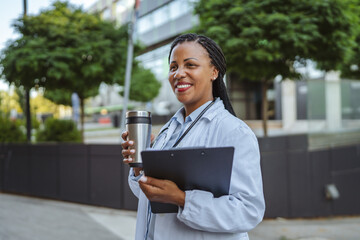 african american woman doctor examining clipboard prepare for patients