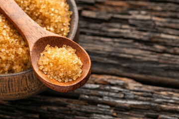 Saccharum officinarum - Organic brown sugar in a spoon and bowl