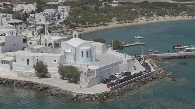 Zoom aerial video of a white church in Pollonia, Milos, Greece. 3x telephoto lens. D-Log M profile. professional video