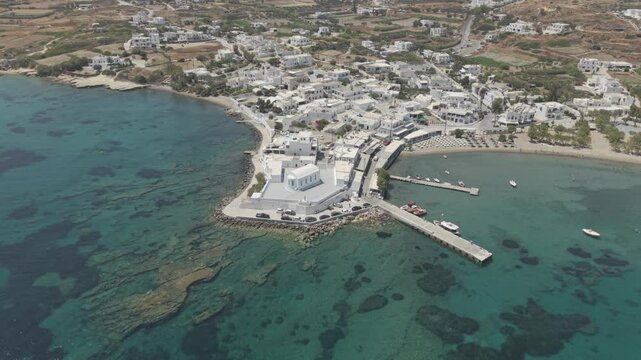 Wide aerial video of a white church in Pollonia, Milos, Greece. 3x telephoto lens. D-Log M profile. professional footage