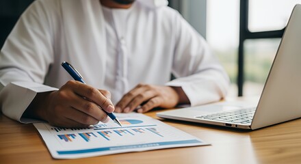 Businessman Analyzing Financial Data on Laptop