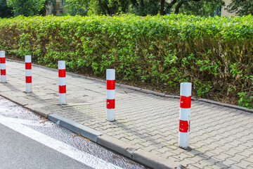 Construction site with red traffic cones lined up on paved surface for safety