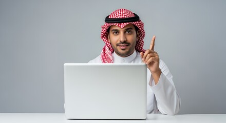 Arab man using laptop, modern technology in traditional setting