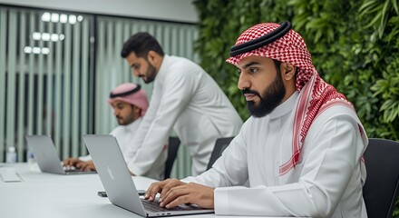 Arab Businessmen Working on Laptops in Modern Office