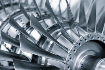 Large metal turbine on table of industrial metalworking programmable CNC machine, industrial machine concept background blue tone © Aleksandr Matveev