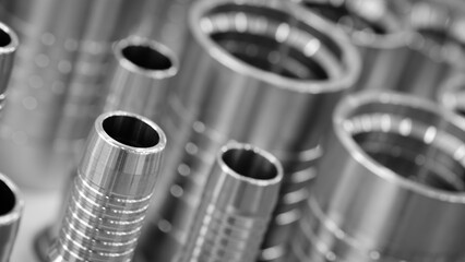 Row metal cylinders with shiny silver finish. cylinders are arranged in neat row, and they appear...