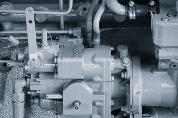 Shown is a large engine with many tubes, bolts and various parts. Auto service concept background