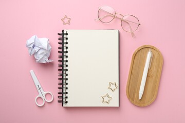 Flat lay composition with notebook on pink background